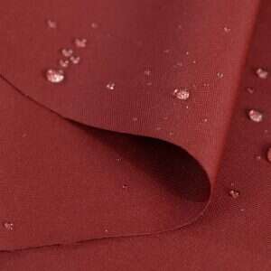 Premium Olefin solid fabric swatch in Claret — outdoor cushion upholstery option