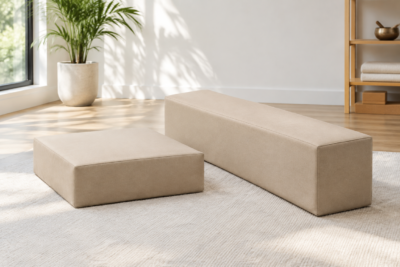 Half-round bolster used as firm low support under the legs in a home stretching corner