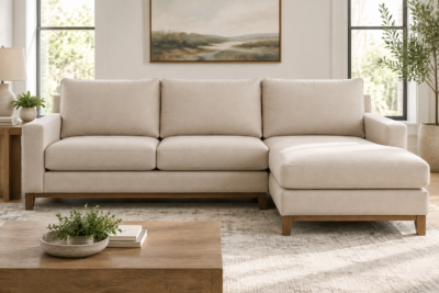 Ashley Luxora sectional with beige replacement cushions layered on the seat