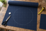 Outdoor egg chair cushion fabric - a bolt of solution-dyed acrylic with a circular pattern piece chalked onto the flat cloth