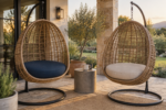 Two hanging egg chairs with thick custom round cushions in navy and sand fabric on a covered backyard patio