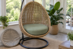 Egg chair cushion replacement - the new thick round pad firm on the woven seat, the old flattened universal pad leaning against the stand