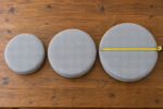 Common egg chair cushion sizes - three thick round pads in twenty, twenty-two and twenty-four inch diameters with a measuring tape across the largest