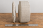 Thin universal round pad versus a thick firm five inch custom round cushion, side view with an inch ruler for scale