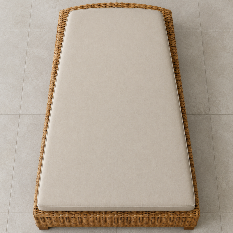 Overhead view of a wicker chaise cushion showing the straight front edge and curved back