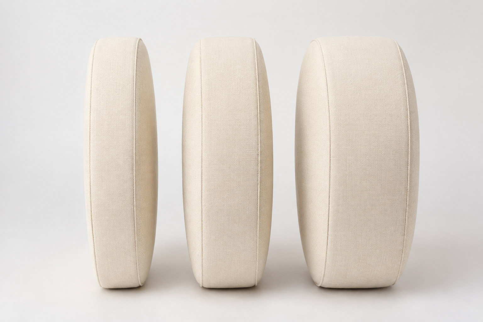 Three round papasan cushion discs standing on edge showing four, five and six inch thicknesses