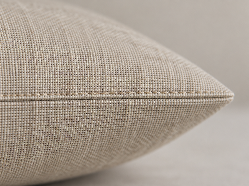 Detail of flat straight knife-edge seam on oatmeal linen window seat cushion