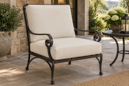 Black wrought iron patio lounge chair with scroll arms fitted with new ivory replacement cushions