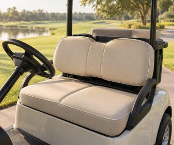 Custom golf cart seat cushions in sand performance fabric fitted on a two-passenger cart at a sunny fairway