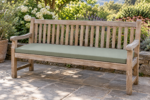 Custom dining bench cushion - weathered teak garden bench with a tailored sage green bench cushion