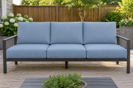 Wide steel-frame patio sofa with thick light blue replacement cushions and full-height back pads